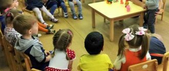 Children sit in a semicircle, teacher and girl in the center